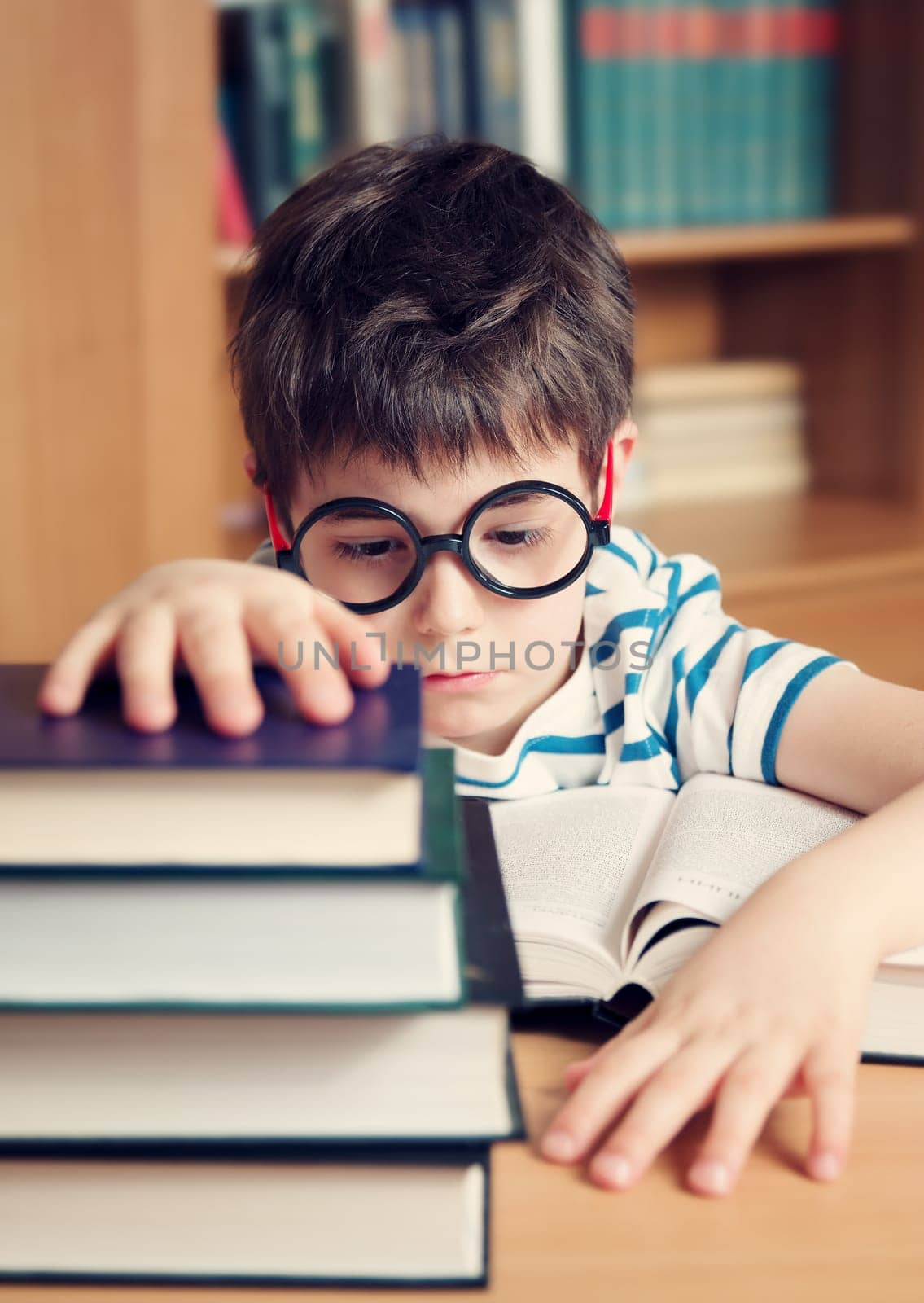 seven years old child reading a book at home
