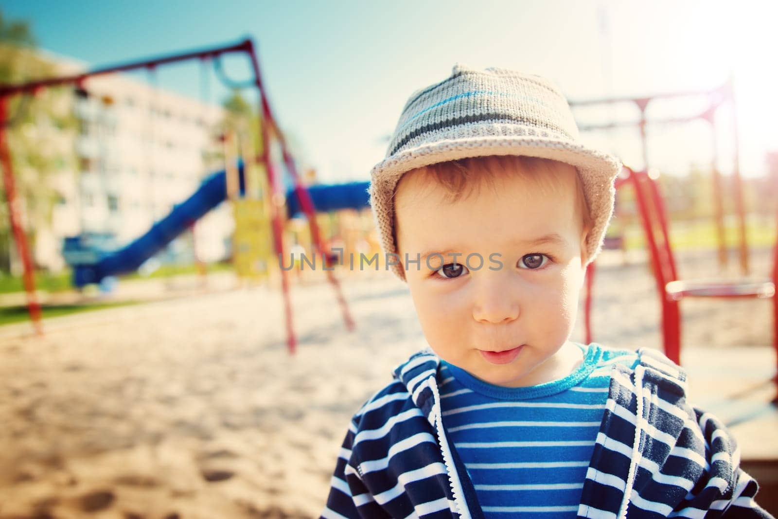 Little boy playing on playground in the spring