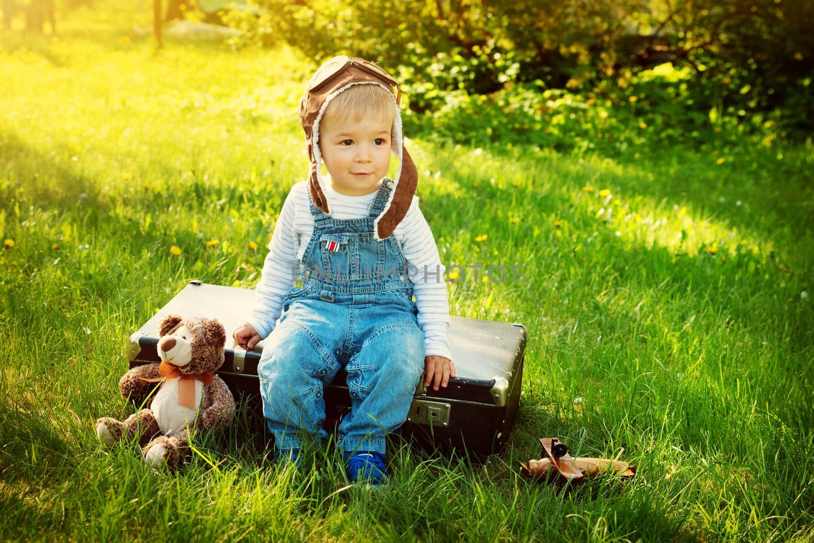 Boy playing in aviator hat in the garden
