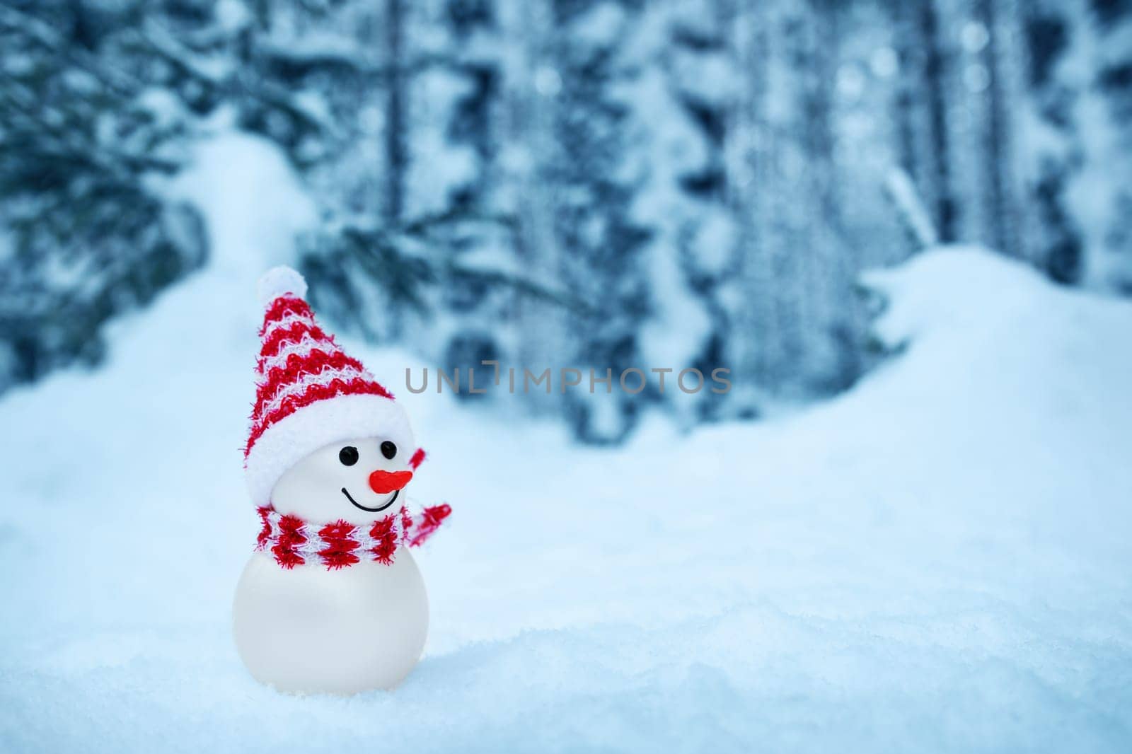 little snowman on soft snow in the forest in winter