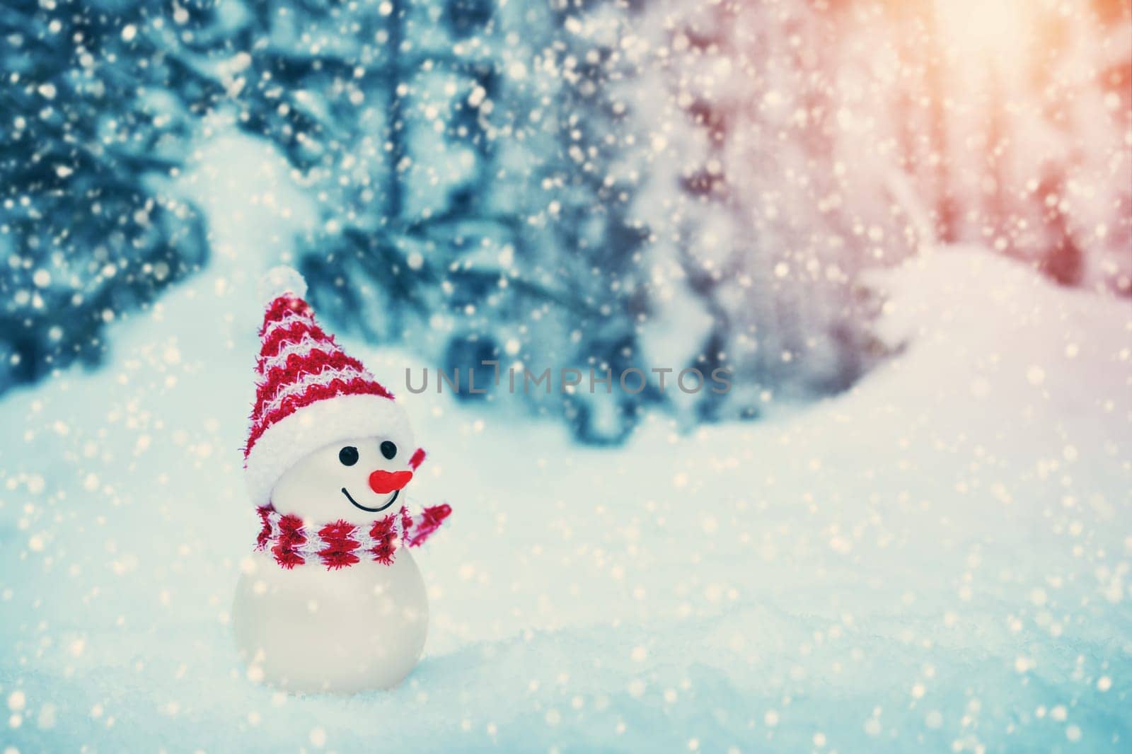 little snowman on soft snow in the forest in winter