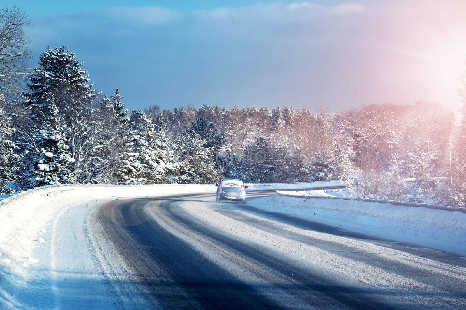 Car tires on winter road covered with snow