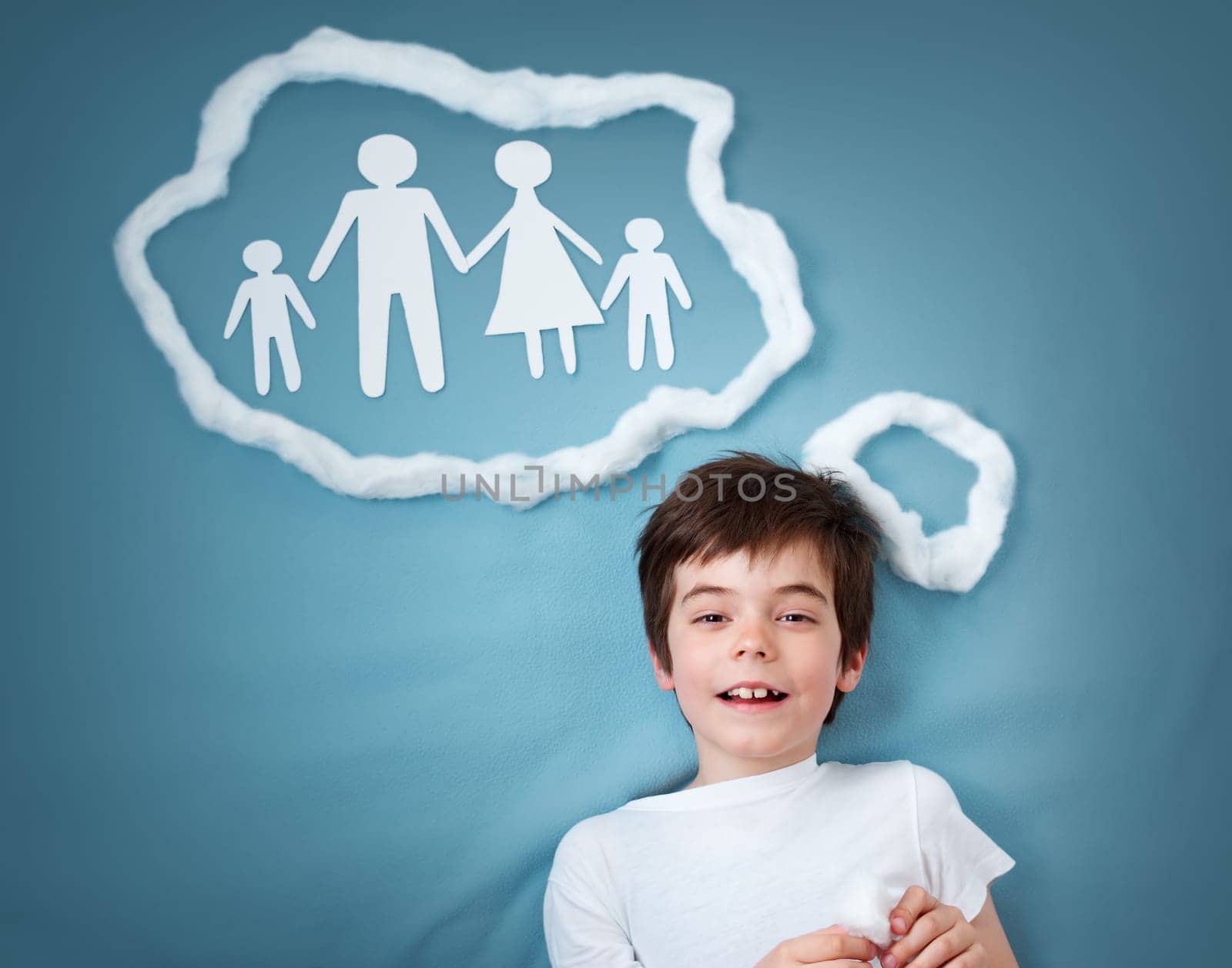 seven years old boy dreaming of a family on blue background
