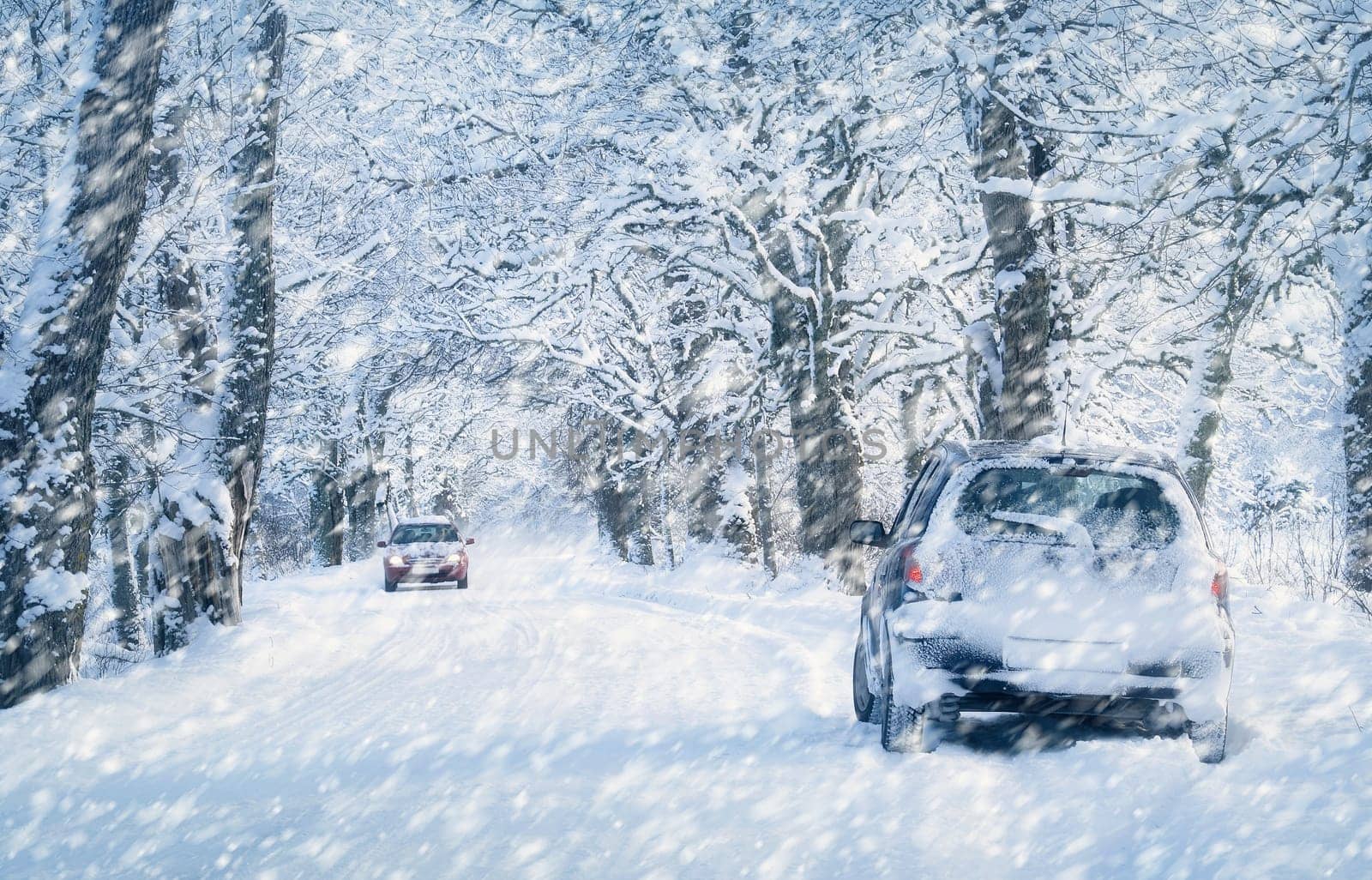 Car tires on winter road covered with snow. Vehicle on snowy alley in the morning at snowfall