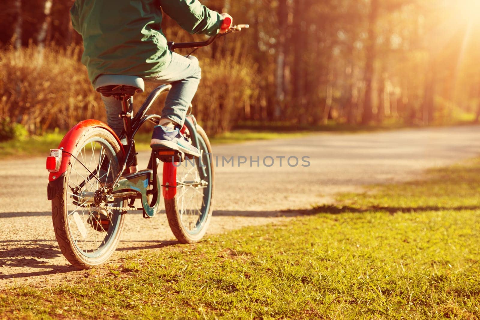 child on a bicycle at asphalt road