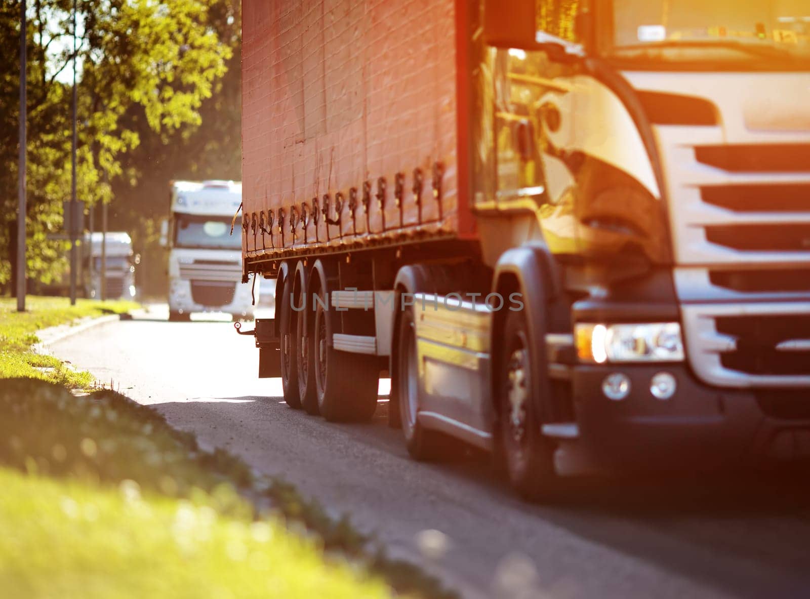 asphalt roadwith a tilt truck. lorry moving on sunny evening