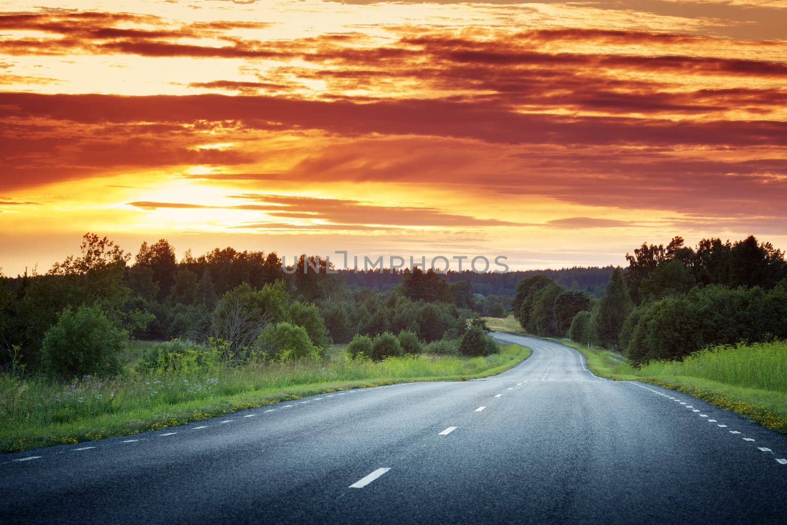 asphalt road view in countryside at beautiful sunset