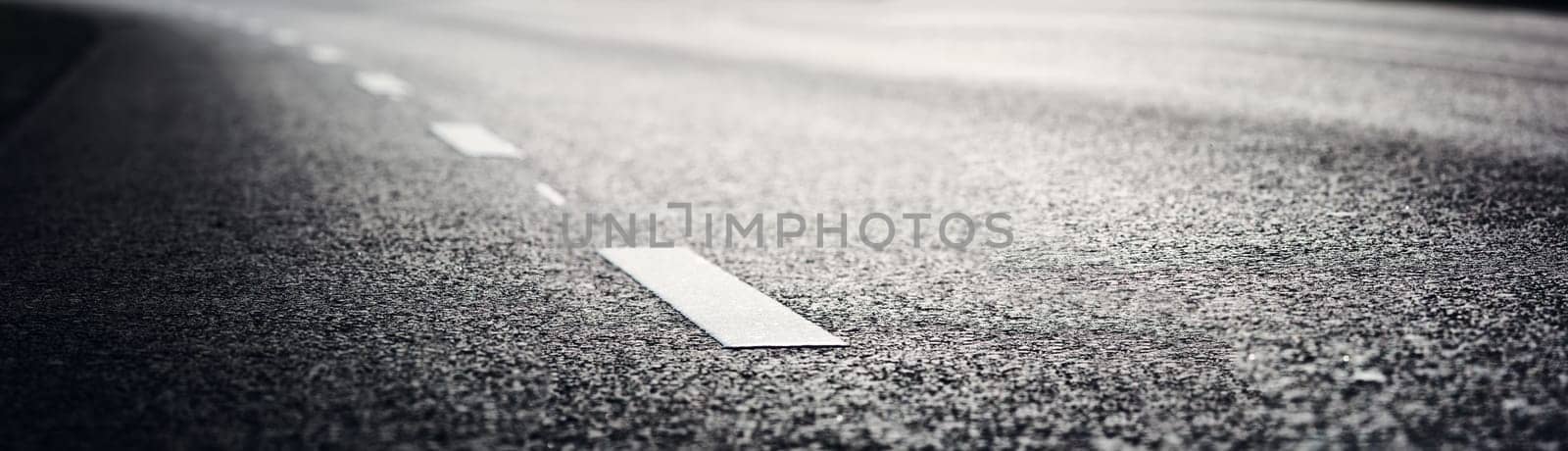 black asphalt road and white dividing lines