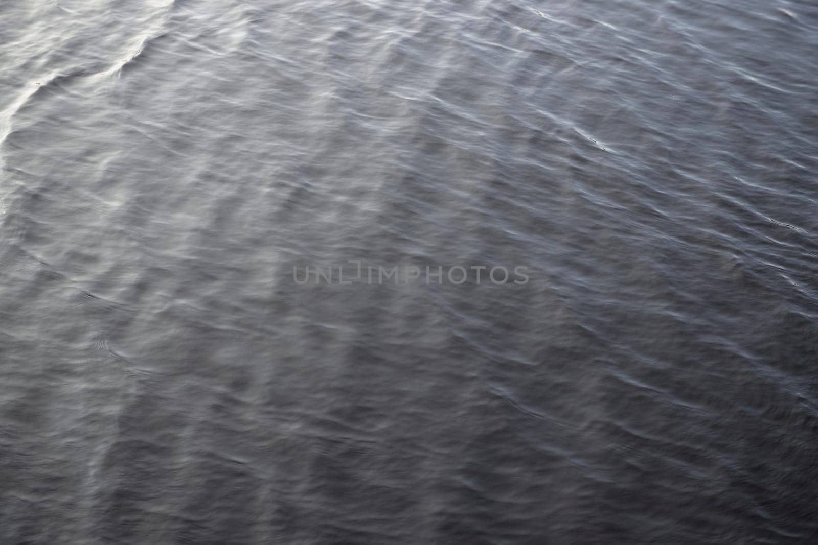 4 - Abstract background water texture, gentle and smooth water ripples. Outdoors reservoir lake, in natural daylight condition. Full frame image