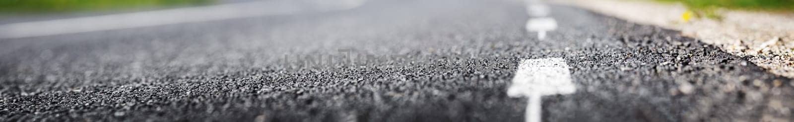 black asphalt road and white dividing lines