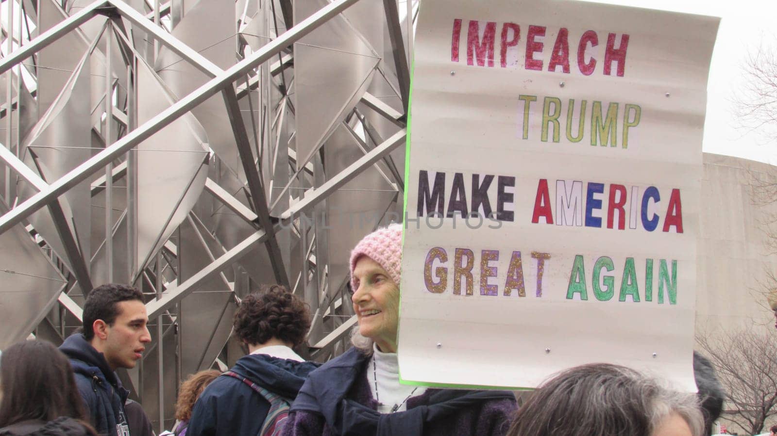 Washington, DC / USA - 01/21/2017: Women's March on Washington pink hats and protest signs, view from the crowd.