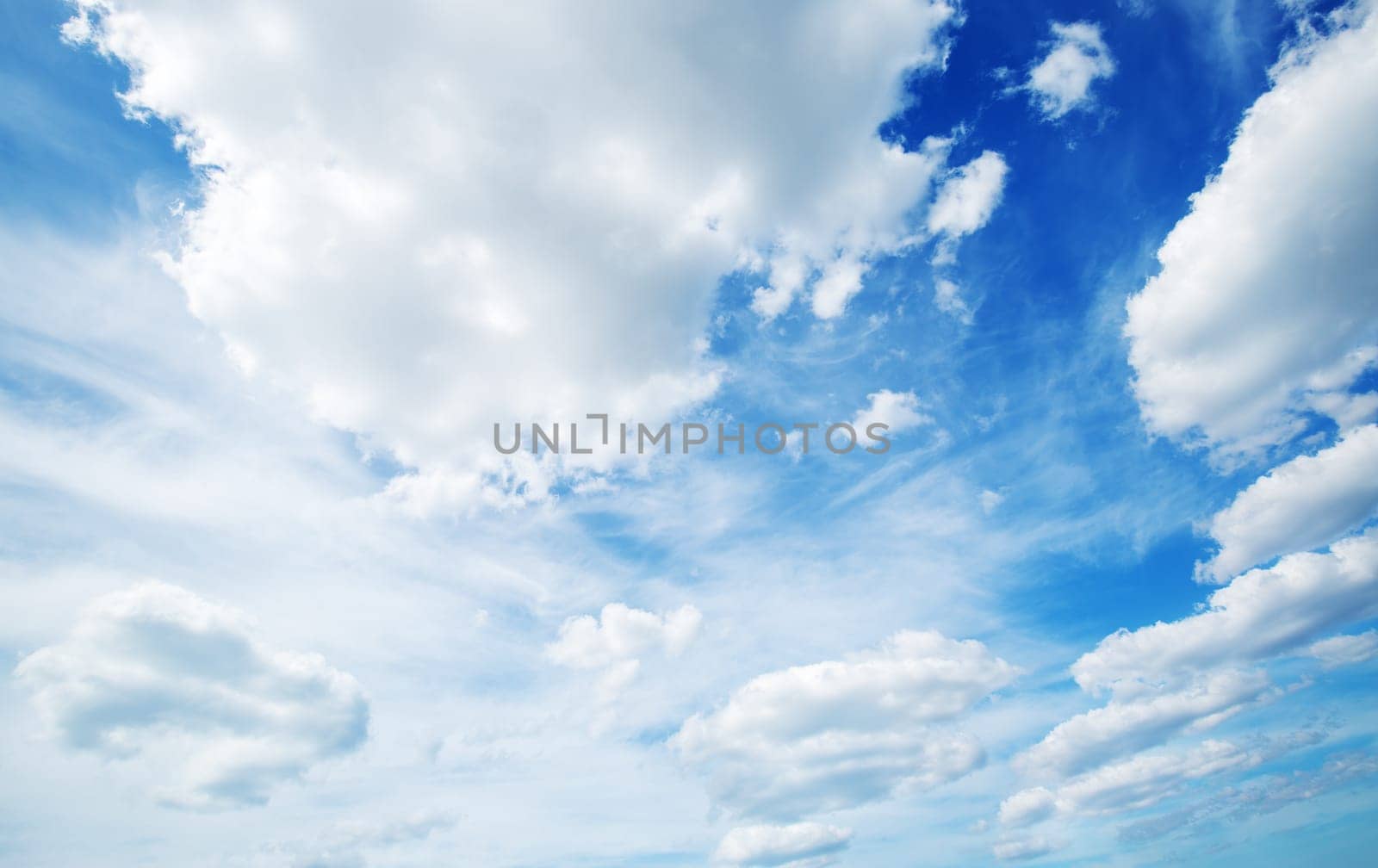 white fluffy clouds on blue sky in summer on sunny day