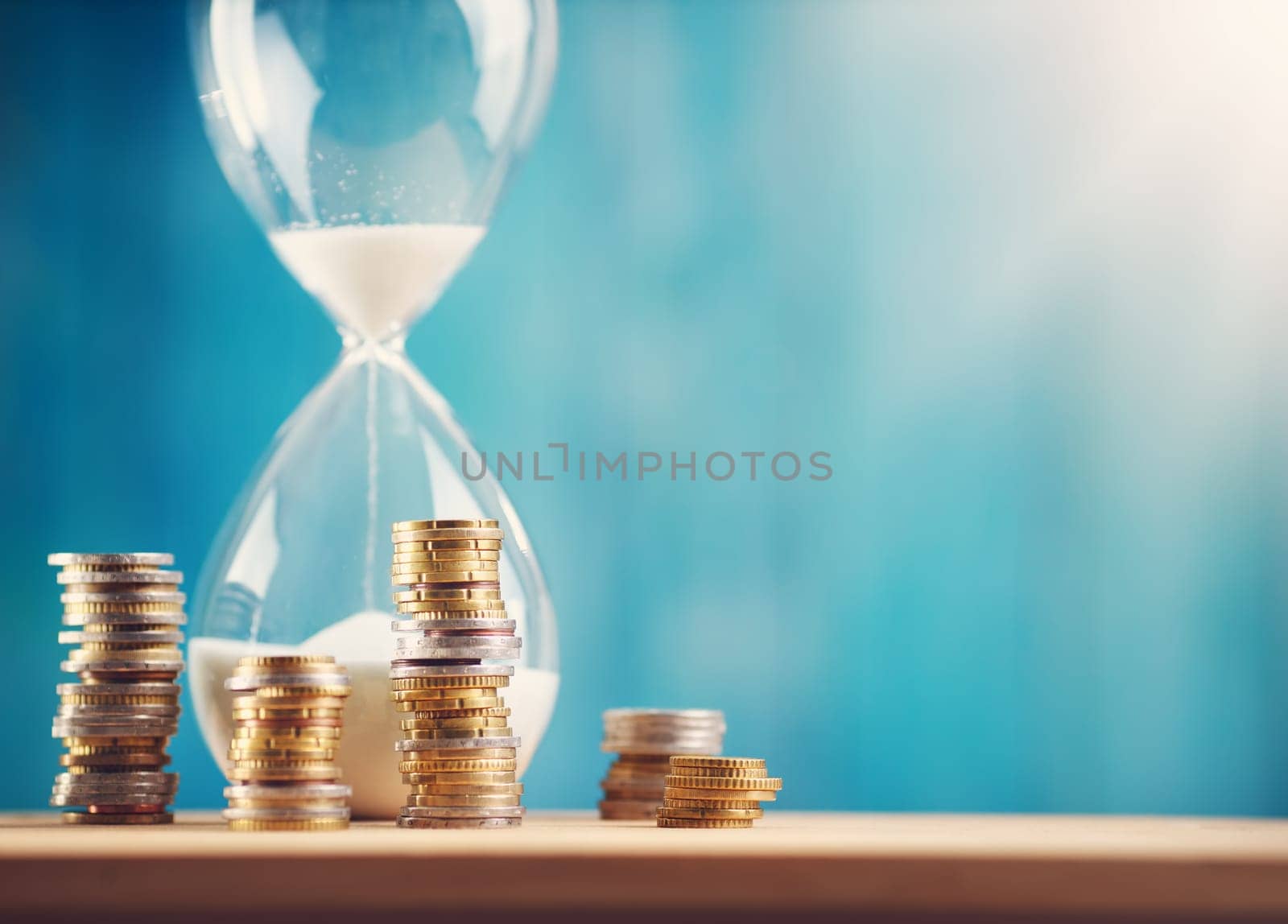 Clock with stacked coins. Pig with money savings and hourglass on blue background