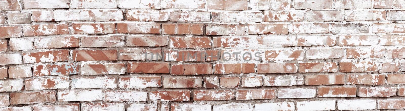 Rustic red brick background with white paint. Dirty wall pattern of an old building. Brickwall texture