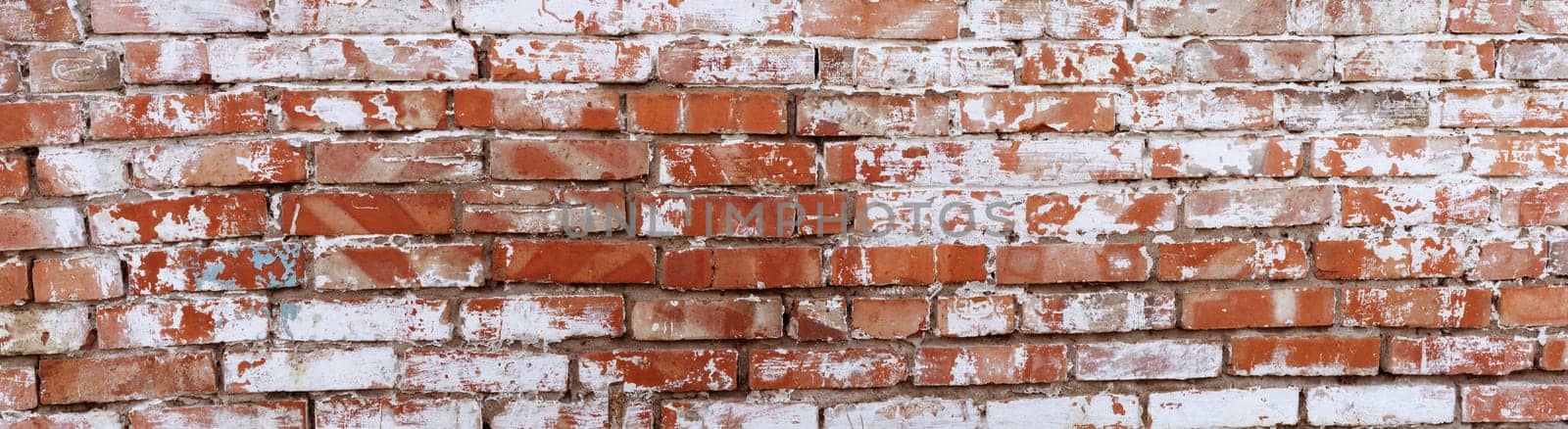 Rustic red brick background with white paint. Dirty wall pattern of an old building. Brickwall texture