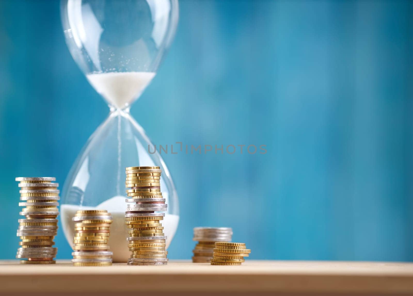 Clock with stacked coins. Pig with money savings and hourglass on blue background