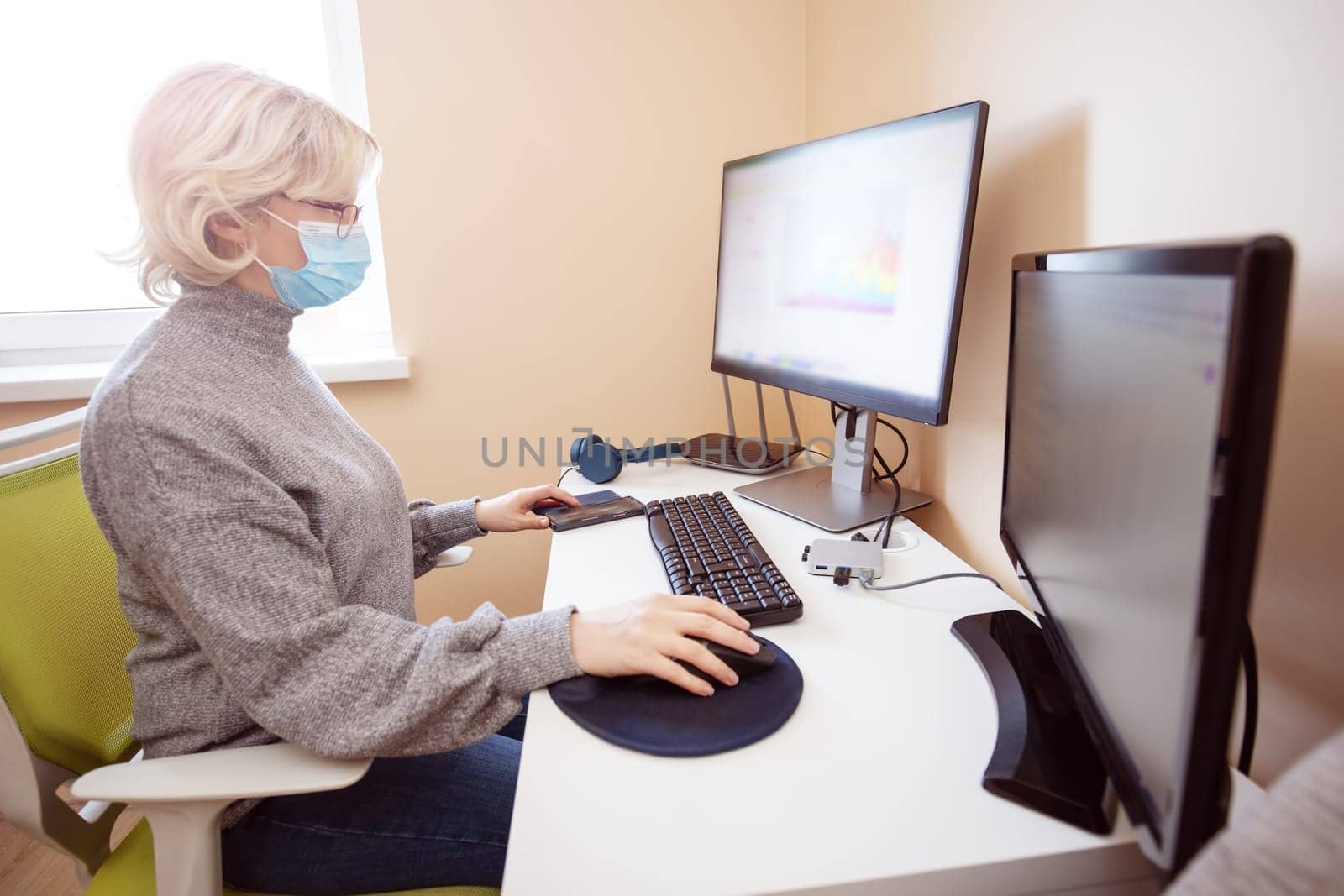 woman working at home in homeoffice. Young businesswoman sitting indoors and using pc