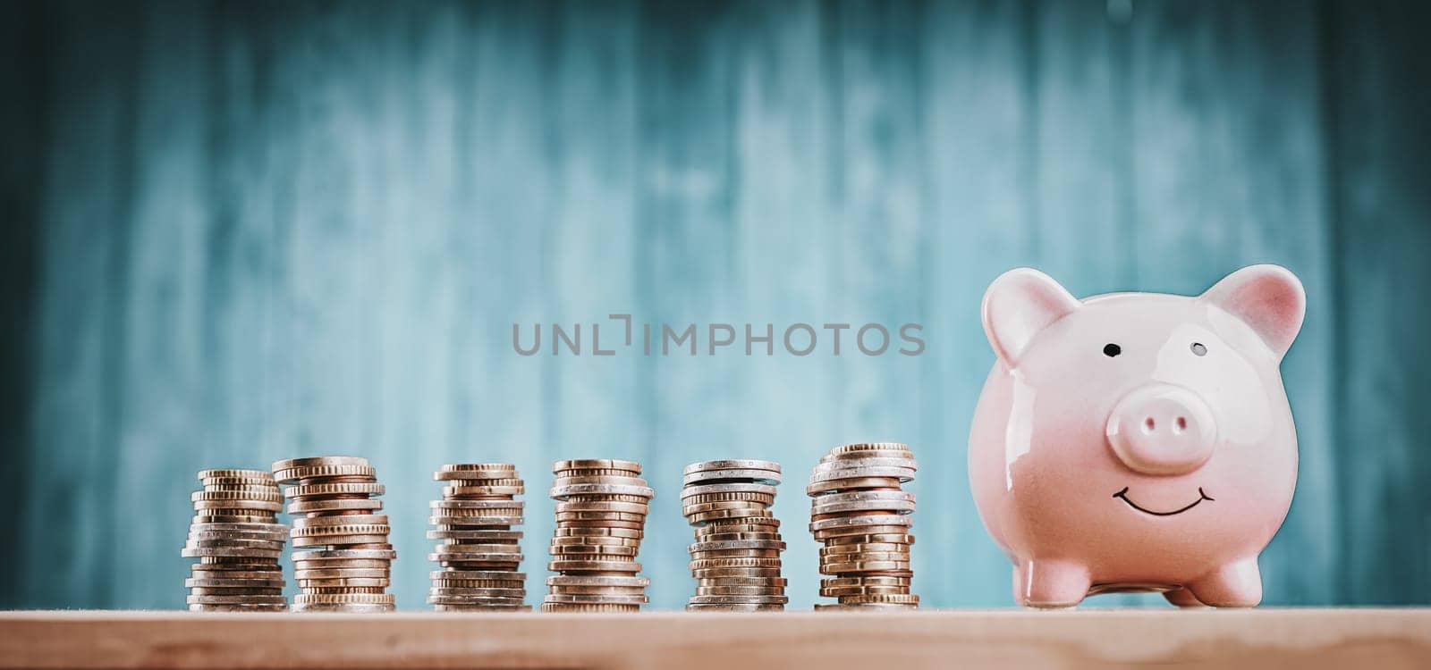 piggy bank with stacked coins. Pig with money savings on blue background