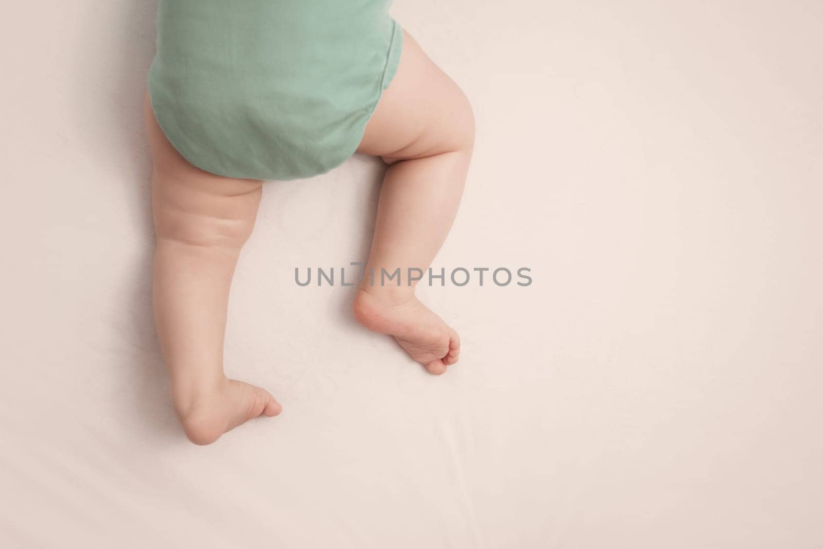 Baby feet on white background with blue blanket