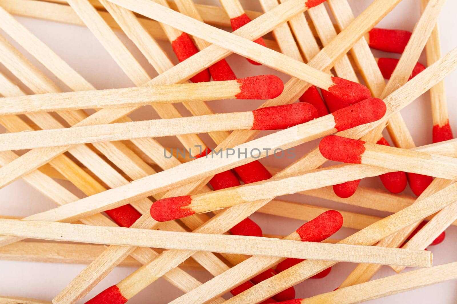front view macro closeup of red wooden match sticks texture on white background