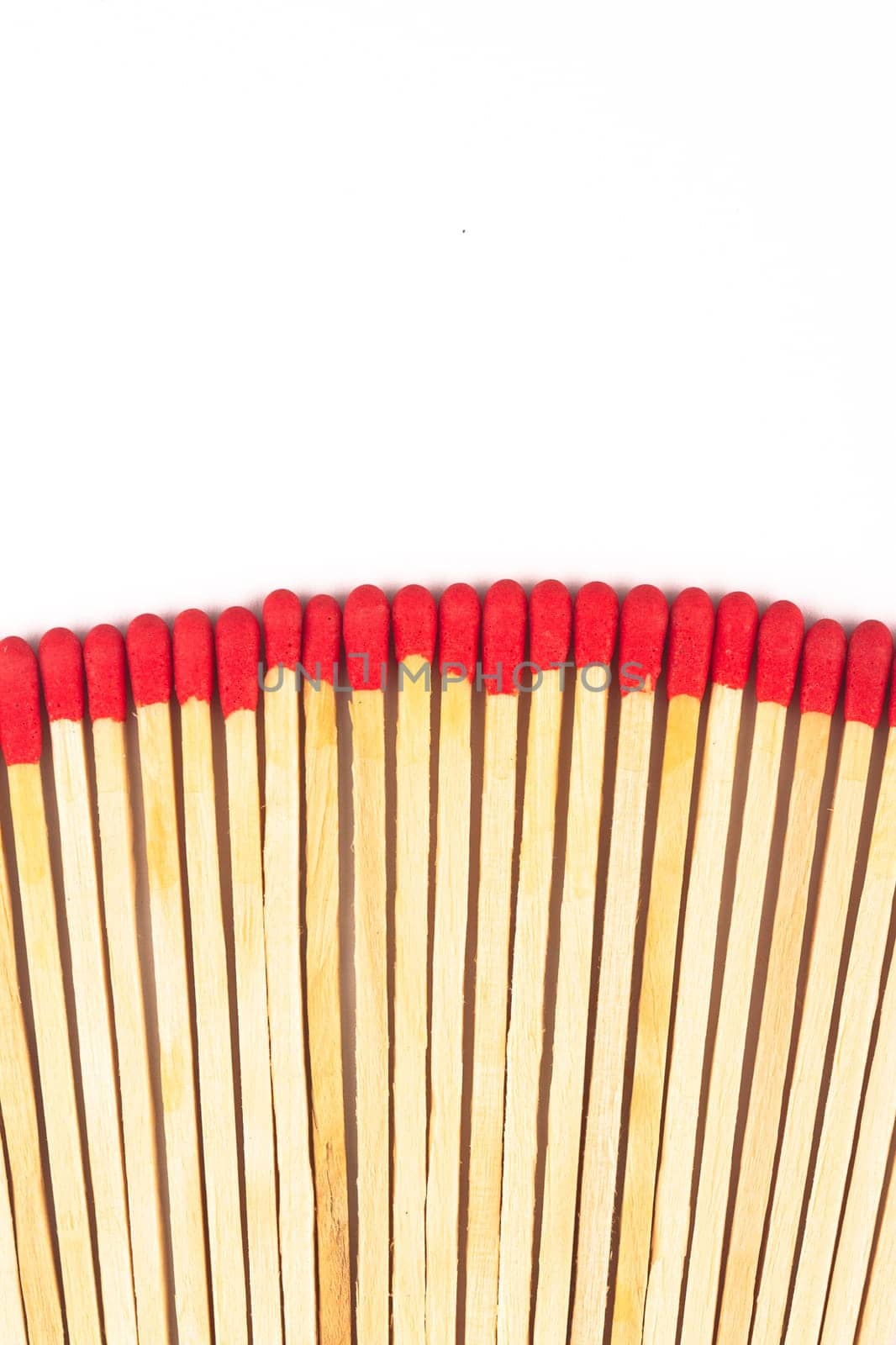 front view macro closeup of long red wooden match sticks isolated on white background