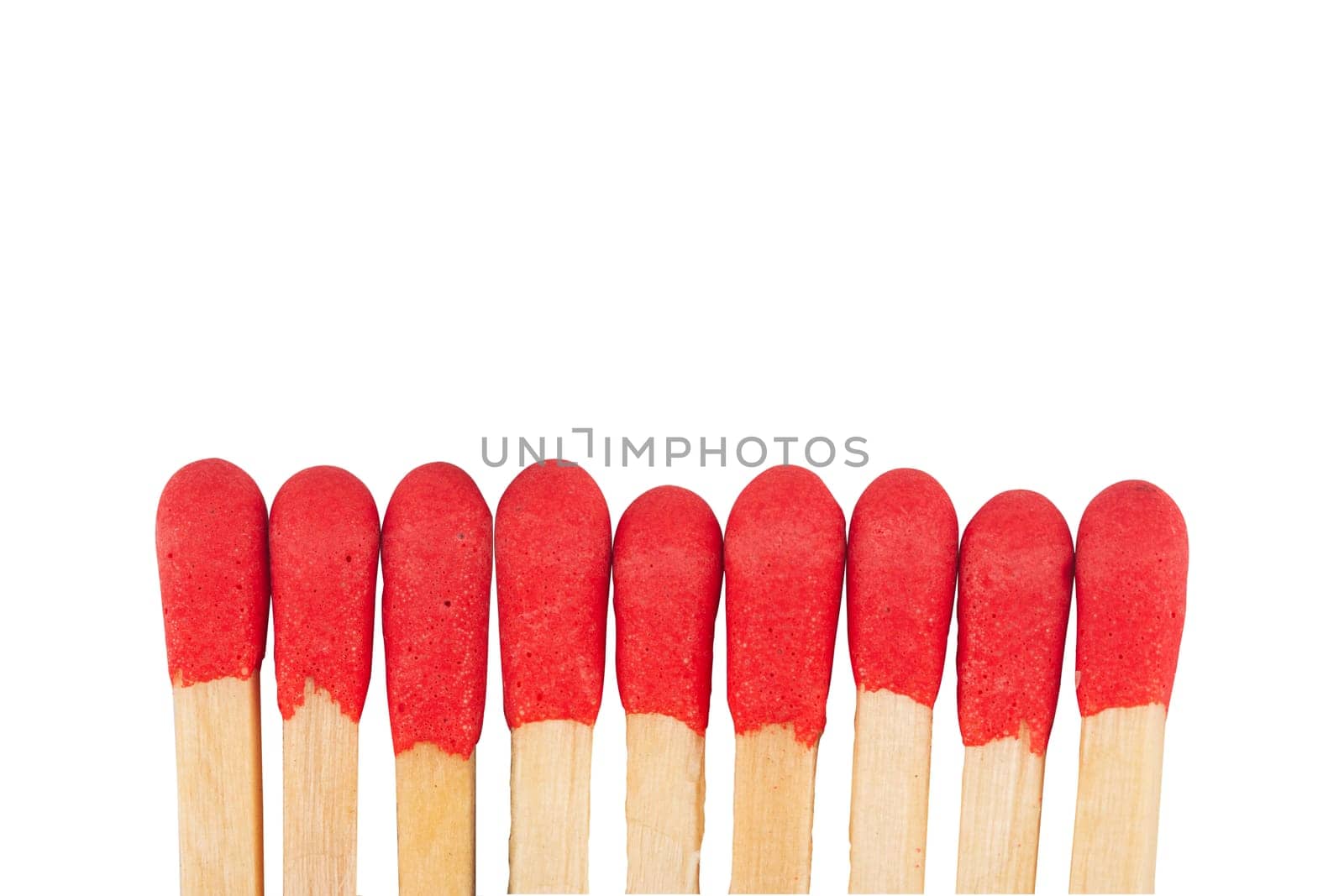 front view macro closeup of red wooden match sticks heads isolated on white background