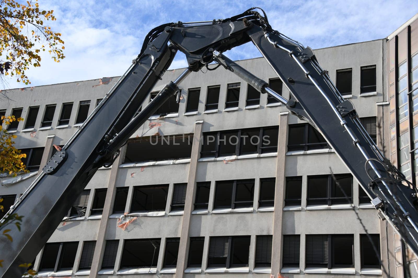 The façade of the office building is still standing. Demolition begins.