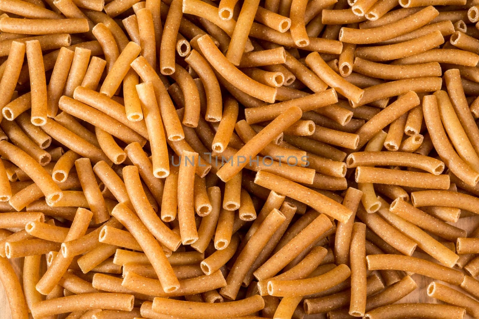 Wholewheat Macaroni lies spread out over the table.