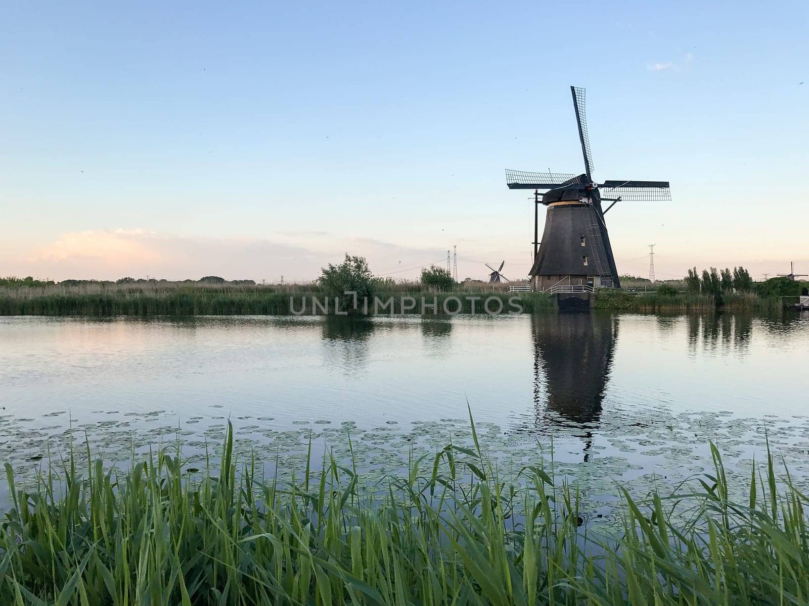 Beautiful dutch windmill landscape at the famous Kinderdijk canals, UNESCO world heritage site