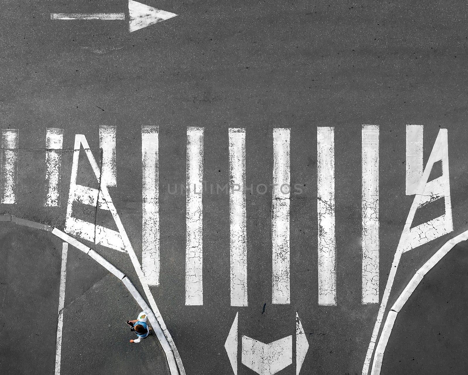 Pedestrian crossing on which people go. View from above. Zebra.