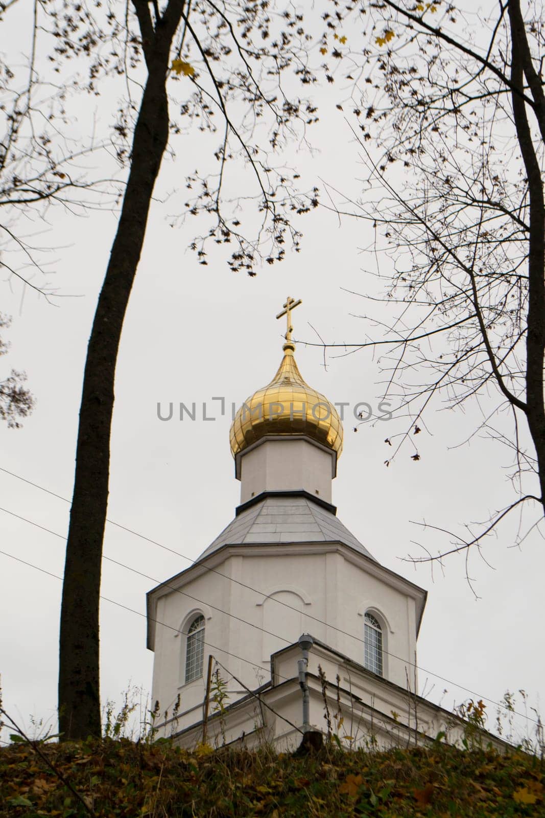 built at the turn of the 19th and 20th centuries in a style reminiscent of classicism, the Orthodox chapel dedicated to Saint Nicholas the Miracle Worker in Logoisk, Belarus. Vertical image
