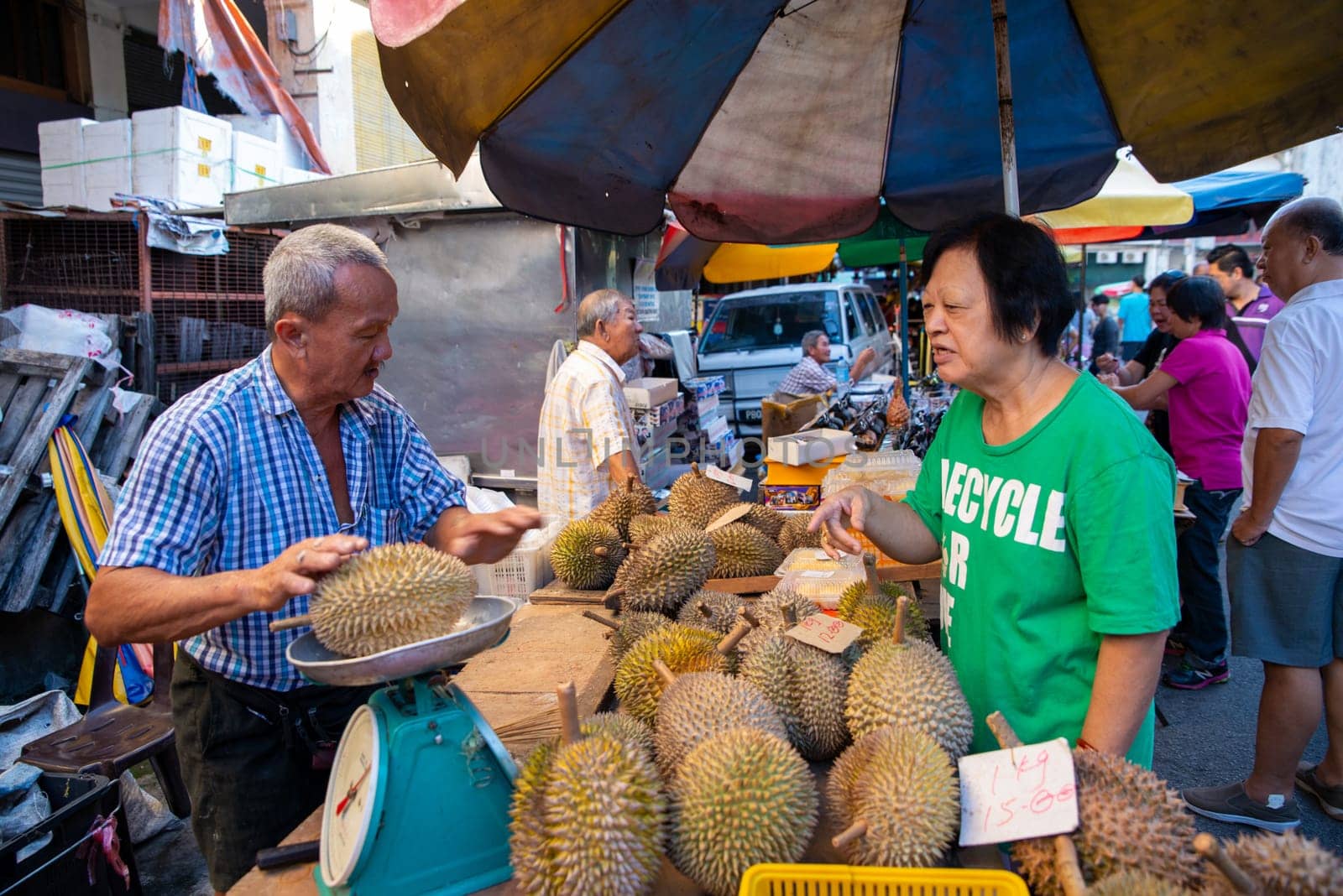 Georgetown, Penang/Malaysia - Jul 30 2016: Durian hawker weight the durian with scale at the wet market.