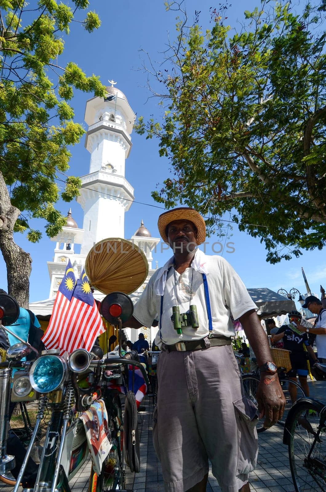 Georgetown, Penang/Malaysia - Jul 30 2016: Old bicycle show with Malaysia flag in front of Masjid Kapitan Keling.