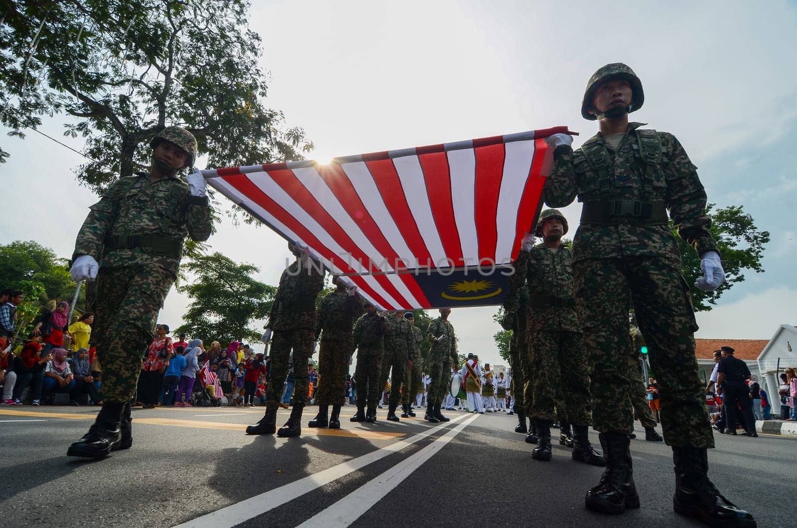 Georgetown, Penang/Malaysia - Aug 31 2016: Low angle soldiers carry large Malaysia flag together.
