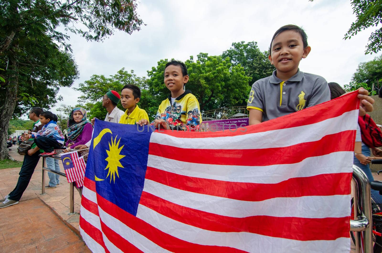 Georgetown, Penang/Malaysia - Aug 31 2016: Kids hold the Malaysia flag during Independence procession.
