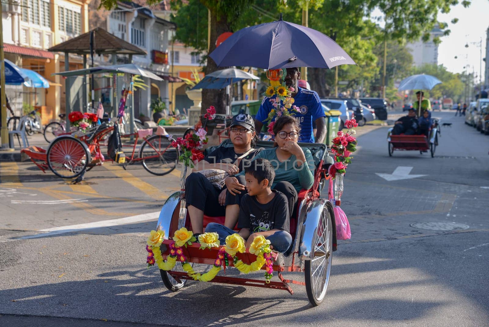 George Town, Penang/Malaysia - Apr 30 2017: A family visit Georgetown by rickshaw.