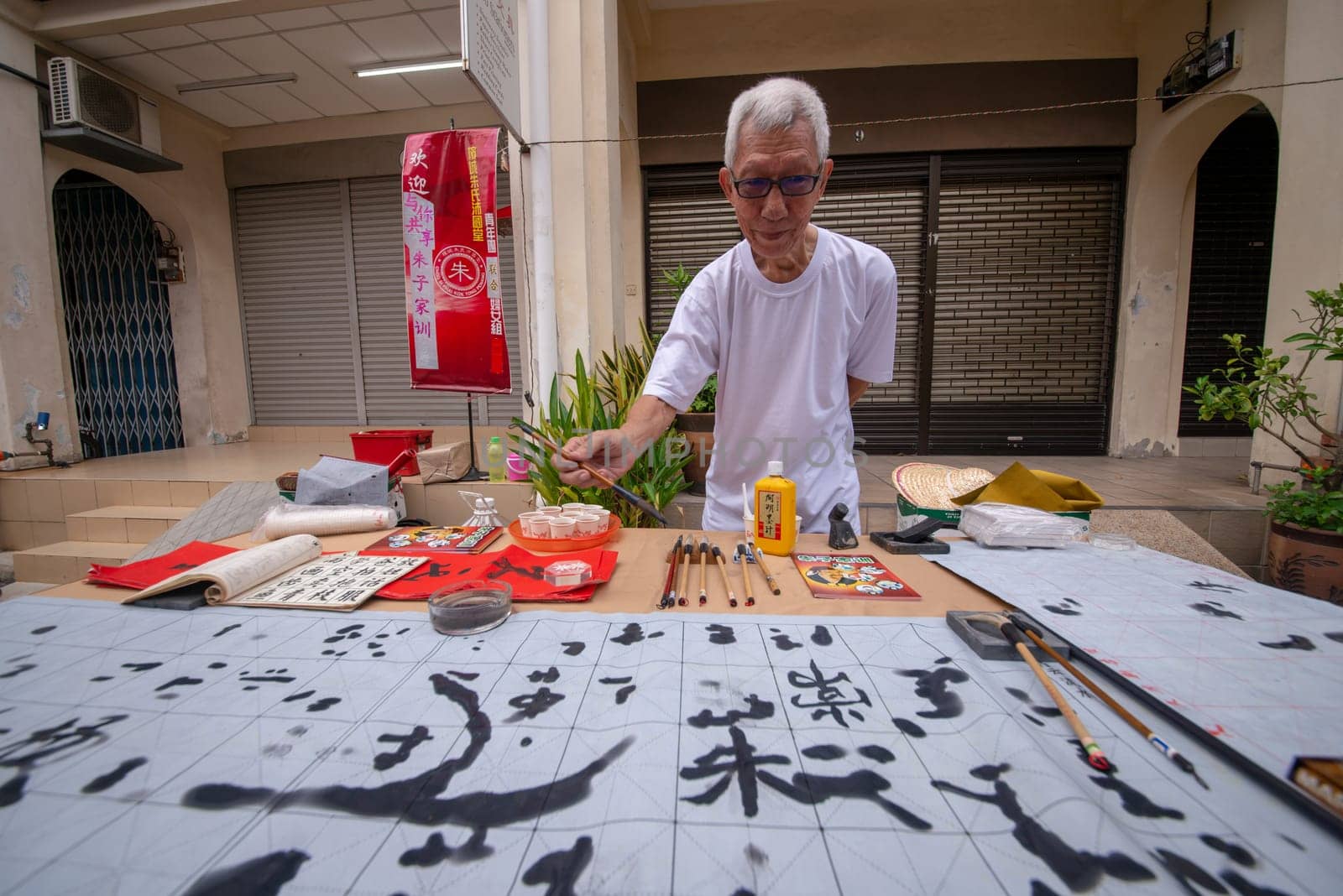 George Town, Penang/Malaysia - Jul 07 2017: A man practice chinese calligraphy at street.
