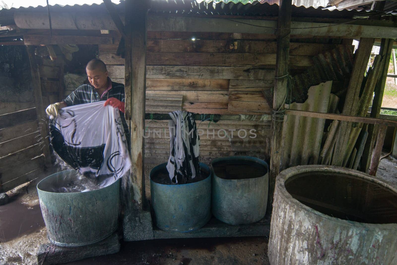 Kota Bahru, Kelantan/Malaysia - Jul 15 2017: An unidentified man wash Batik