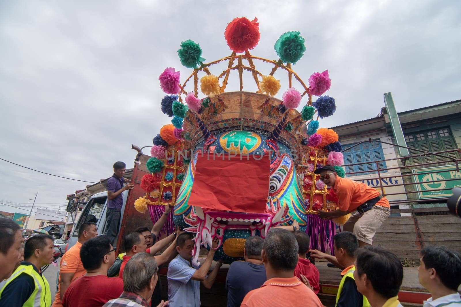Bukit Mertajam, Penang/Malaysia - Aug 22 2017: Chinese devotees hold the head of ghost king from truck to assembly.