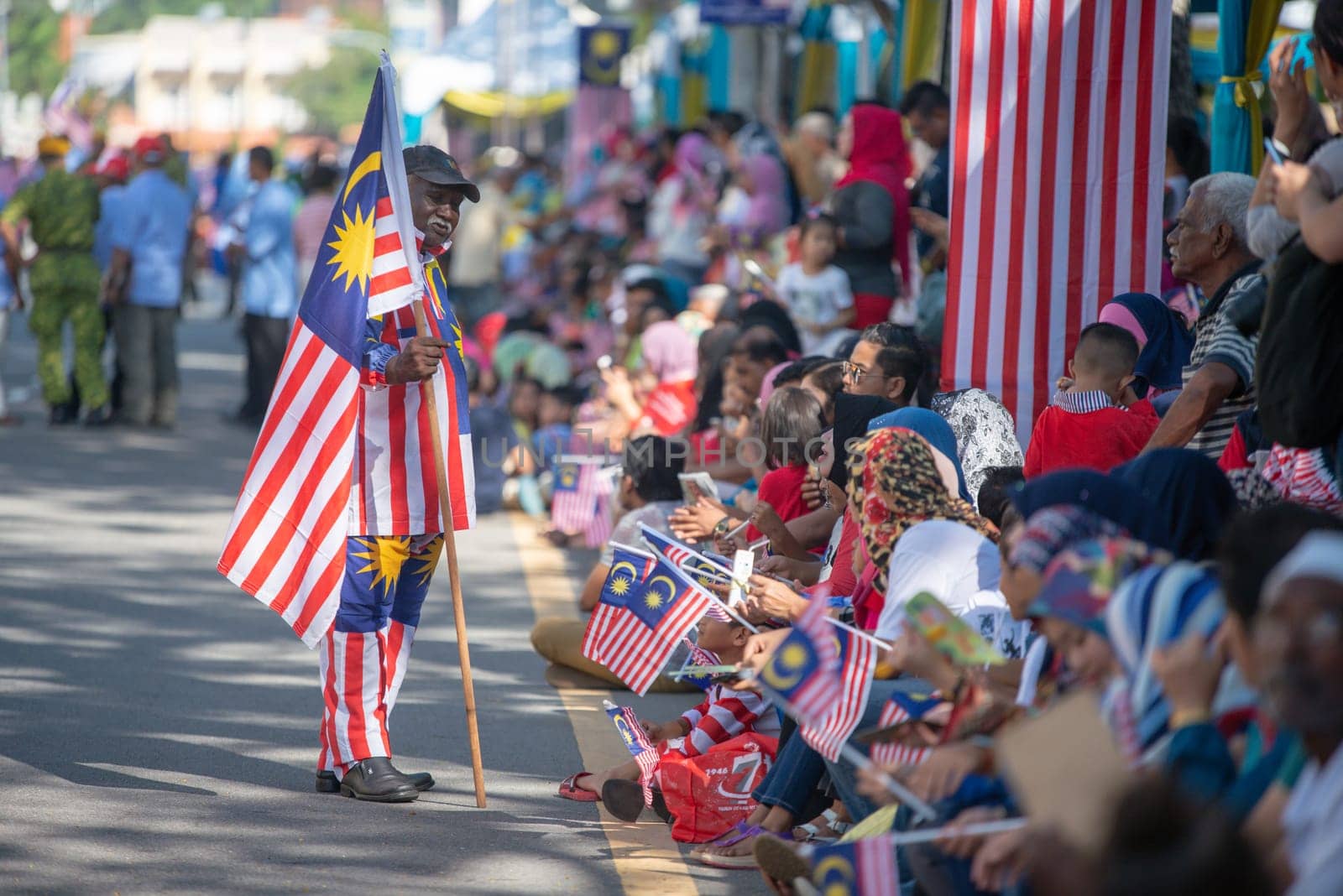 George Town, Penang/Malaysia - Aug 31 2017: A man hold Malaysia flag at national day parade.