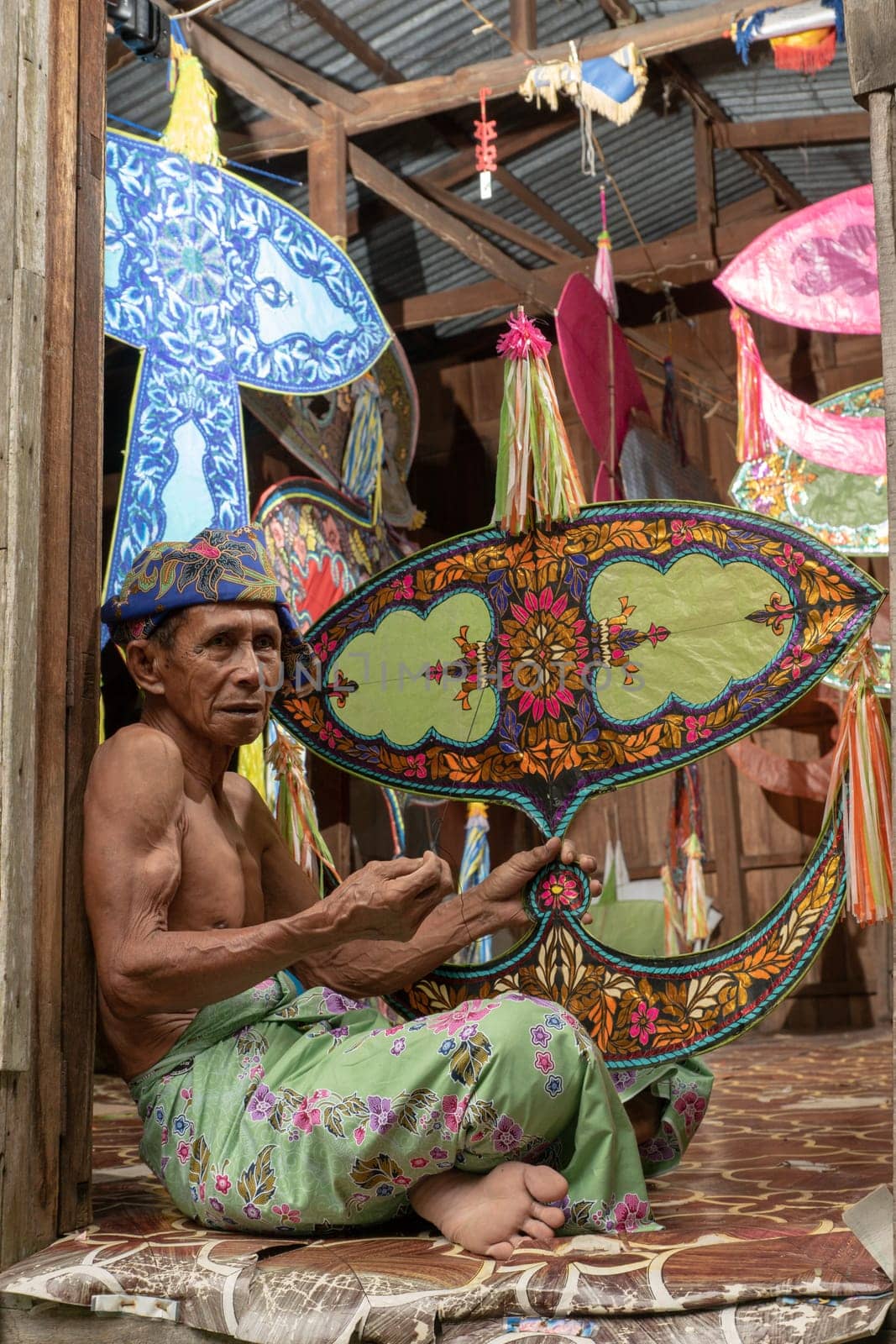Kota Bahru, Kelantan/Malaysia - Jul 15 2017: Moon kite maker hold the wau.