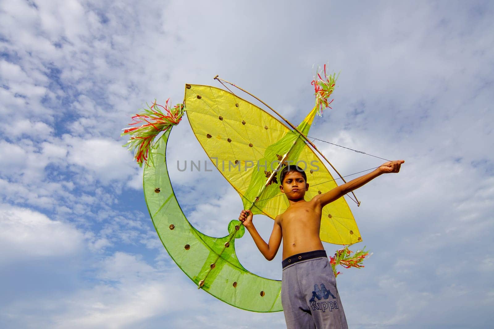 Kota Bahru, Kelantan/Malaysia - Jul 15 2017: Asian kid play traditional moon kite (wau bulan).