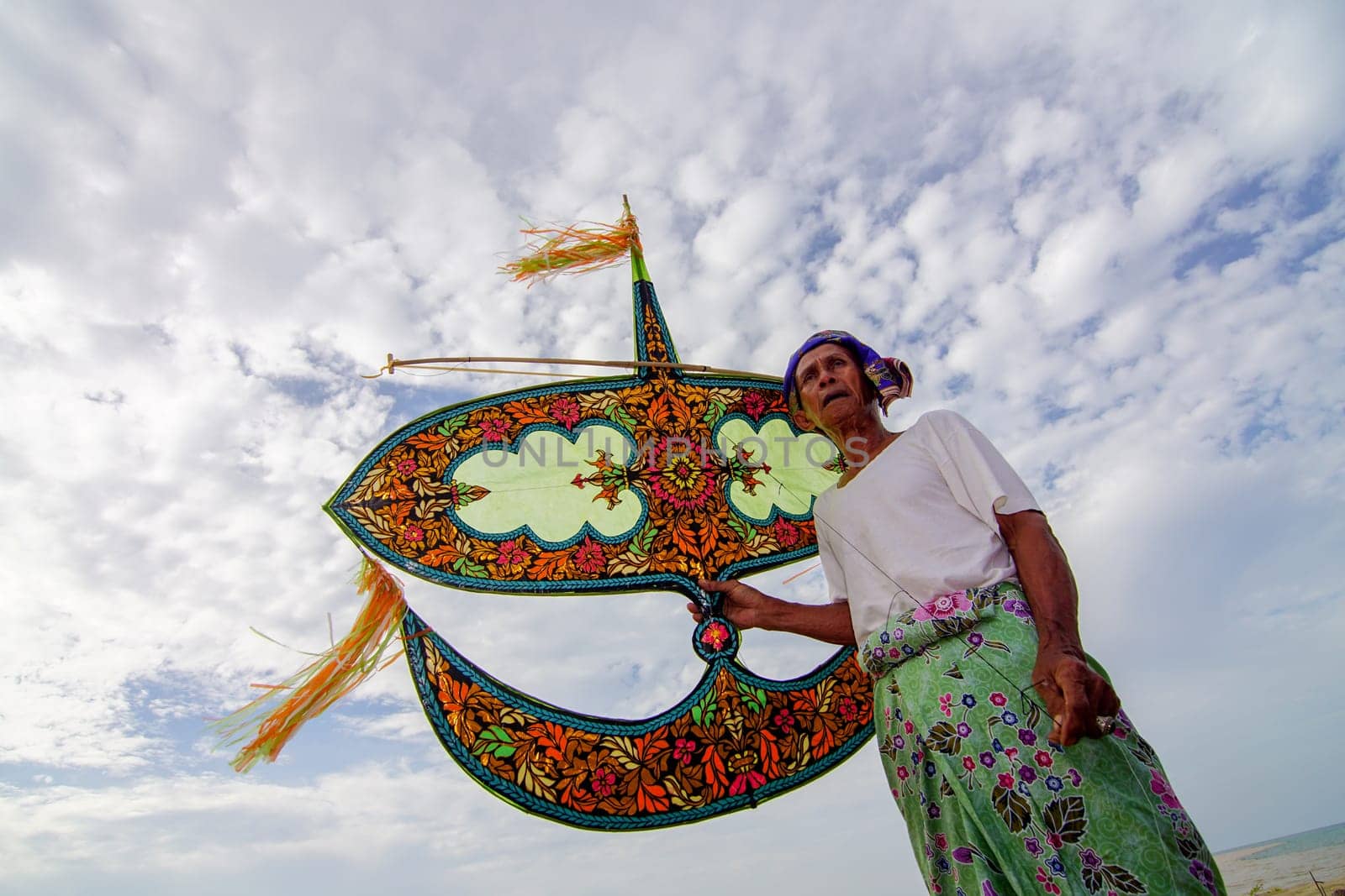 Kota Bahru, Kelantan/Malaysia - Jul 15 2017: A man with his hand made kite in bright sunny day/
