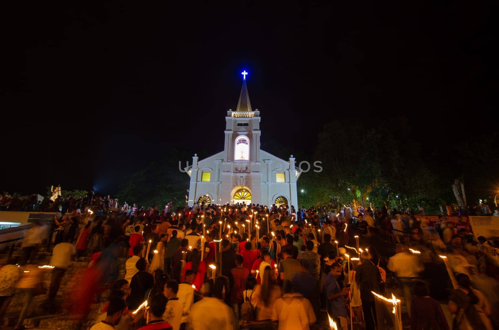 Bukit Mertajam, Penang/Malaysia - Jul 29 2017: Devotees hold the candle and walk into the church at night during St Anne feast.