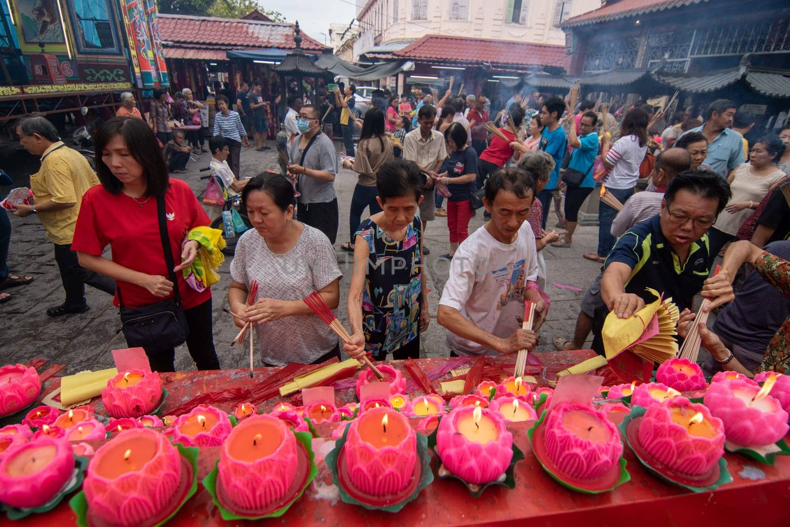 George Town, Penang/Malaysia - Jul 31 2018: Chinese devotees burn the joss stick in front of lotus candle light.