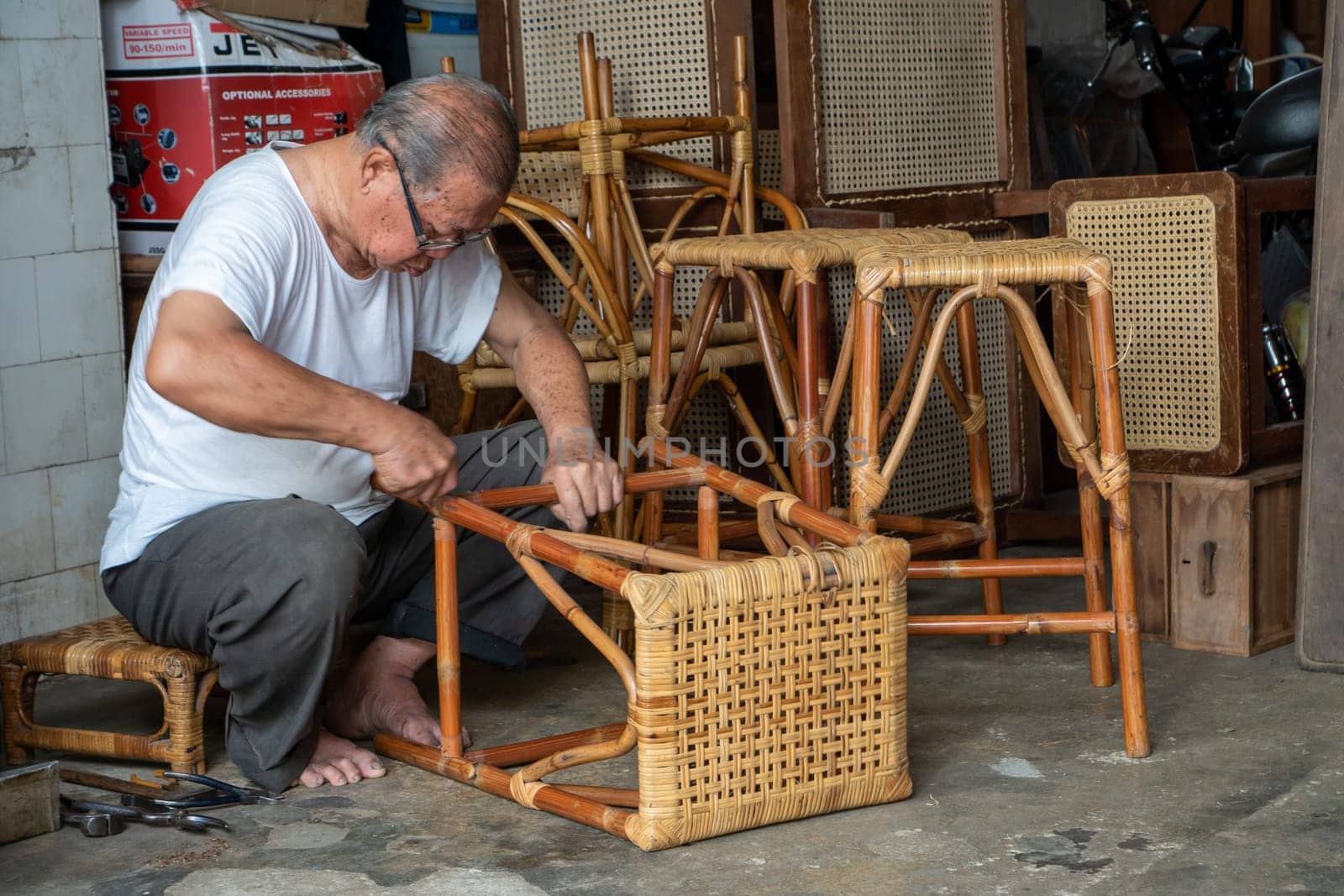 George Town, Penang/Malaysia - Jul 19 2018: A man repair rattan chair.