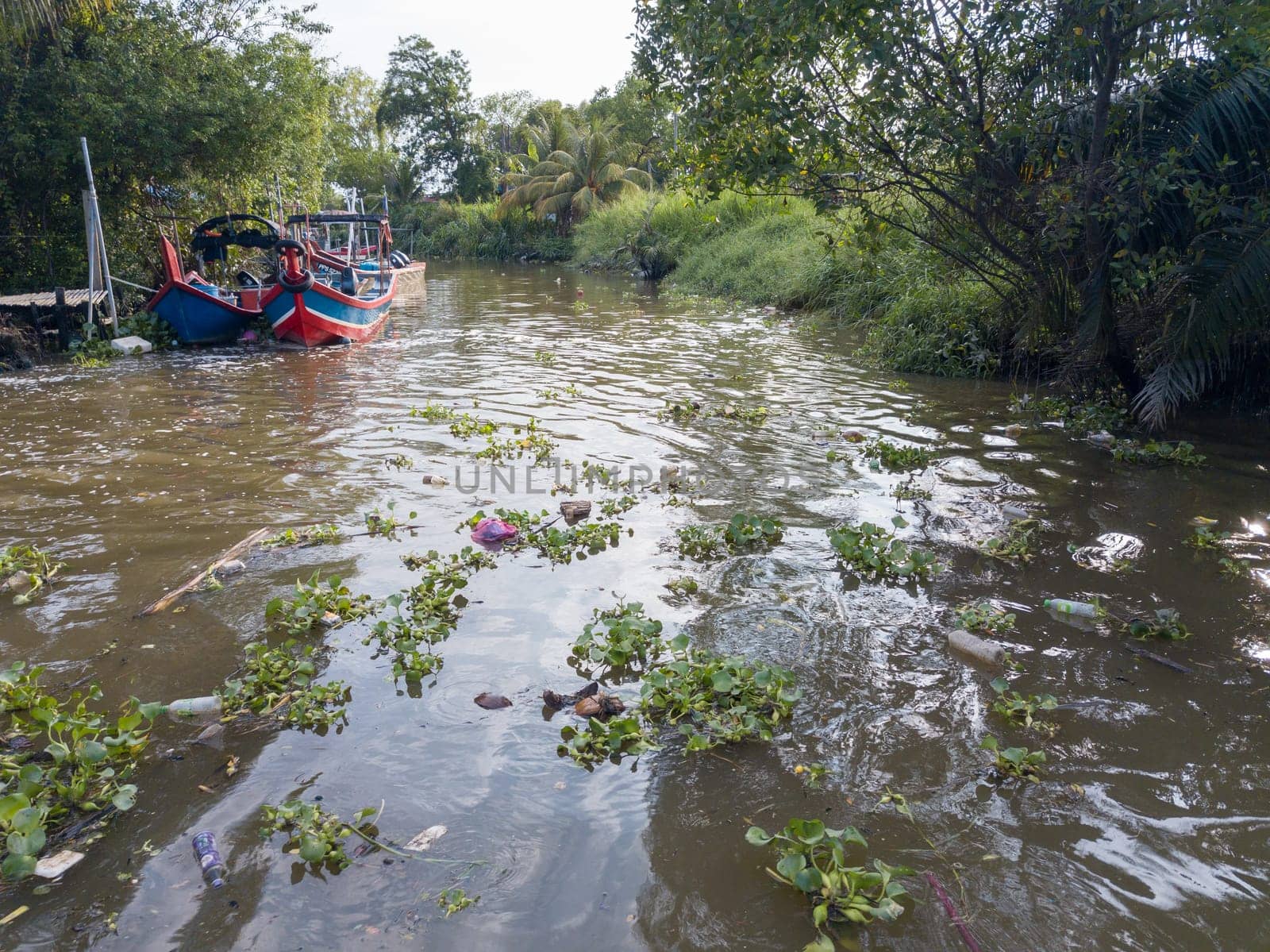 Bukit Tambun, Penang/Malaysia - May 07 2019: Rubbish flow in river near fishing village
