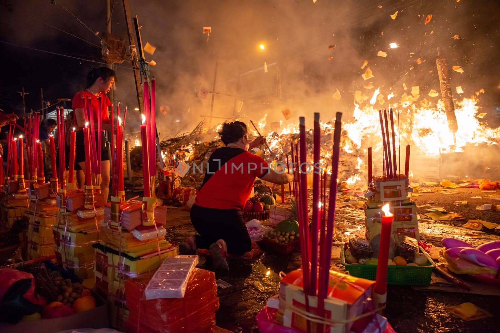 Bukit Mertajam, Penang/Malaysia - Aug 17 2019: Chinese devotees pray with joss paper and stick during hungry ghost festival.