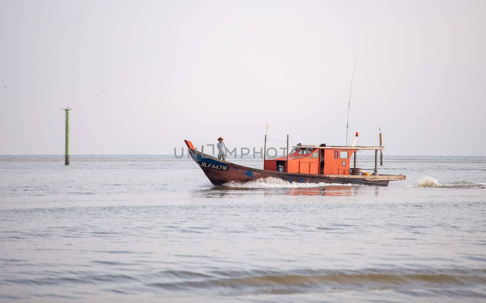 Sekinchan, Selangor/Malaysia - Oct 06 2019: A fisherman stand in front of boat go back home.