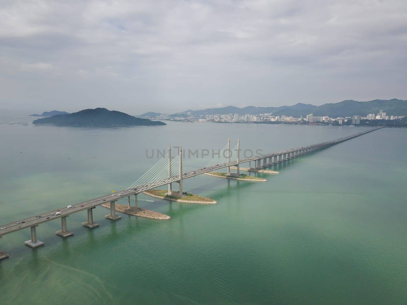 George Town, Penang/Malaysia - Oct 24 2019: George Town, Penang/Malaysia - Oct 24 2019: Aerial view Penang Bridge with island at background.